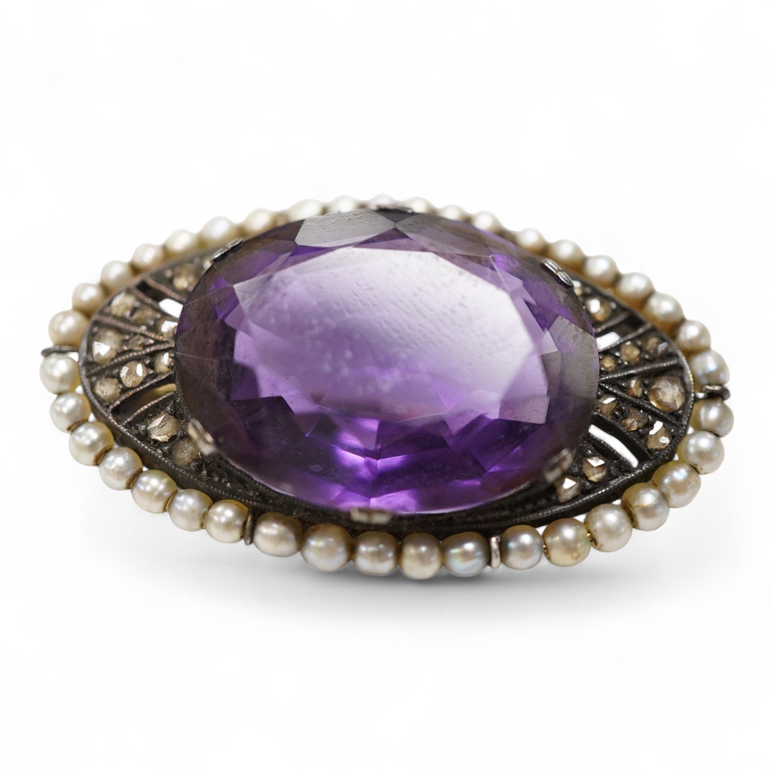 An early 20th century Austro-Hungarian 14k, amethyst, diamond and seed pearl set oval brooch, 37mm, gross weight 10 grams.
